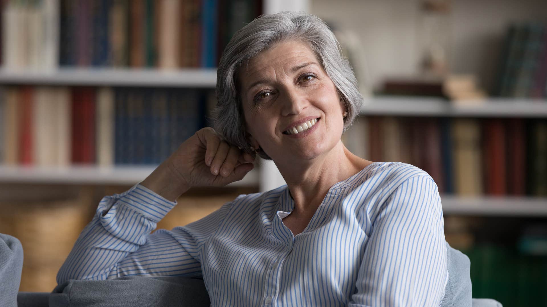 Calm woman smiles showing emotional strength from being alone