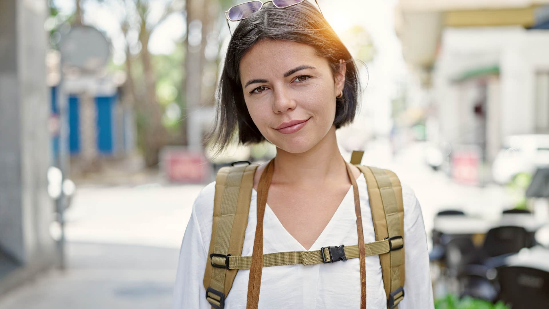 Adventurous woman with shorter hair smiling outside