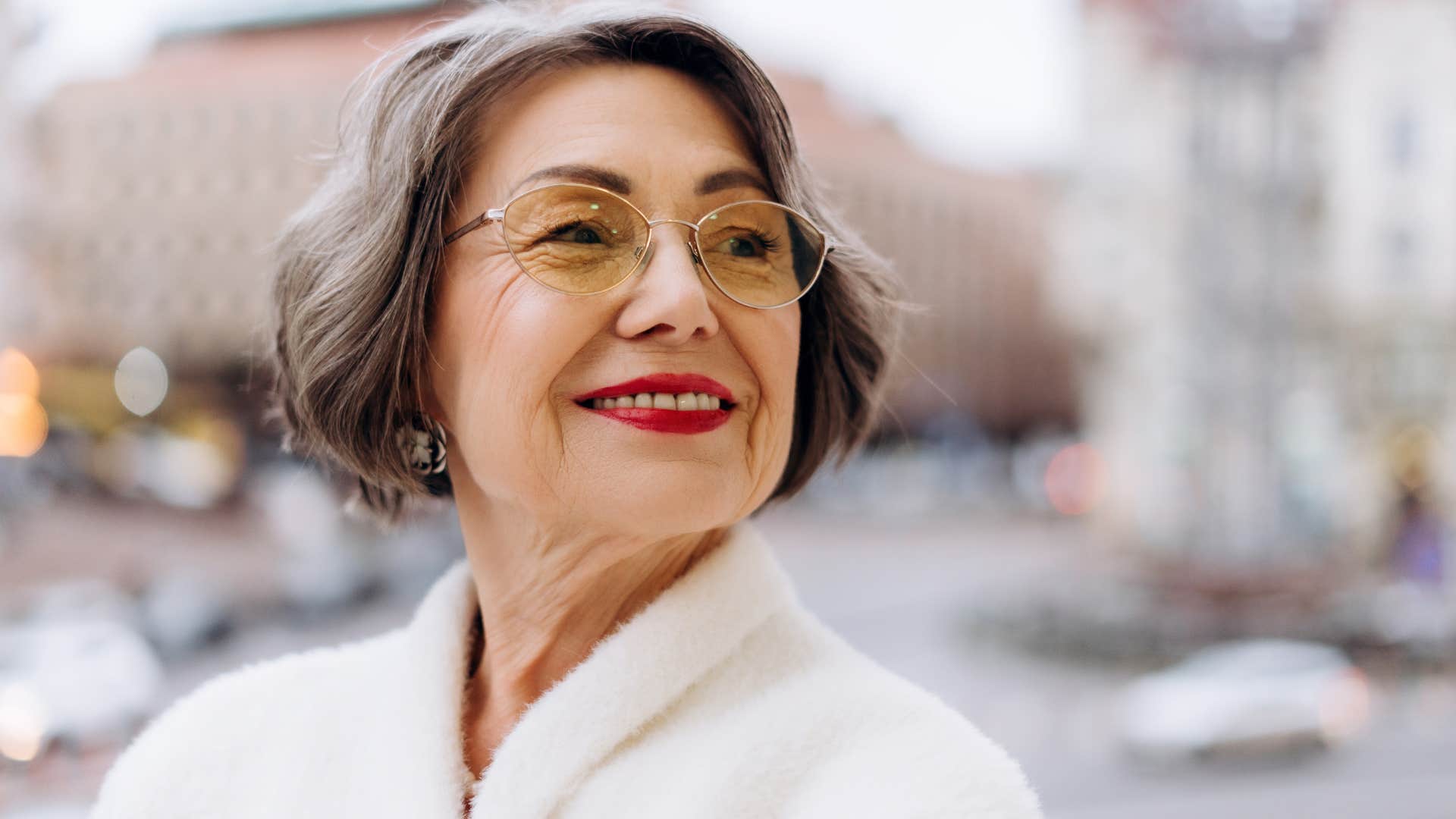 Woman with shorter hair who's comfortable with herself smiling