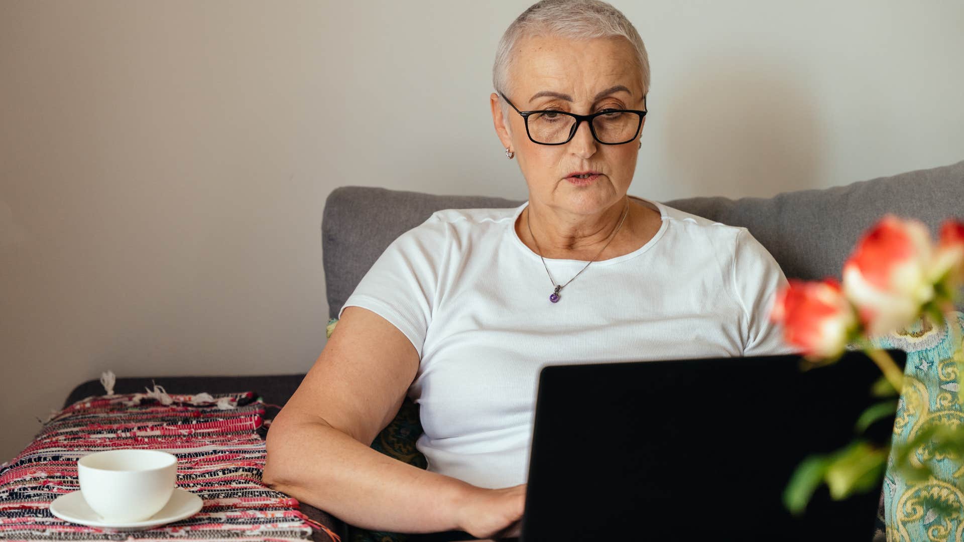Woman with short hair who's not afraid to stand out working at home