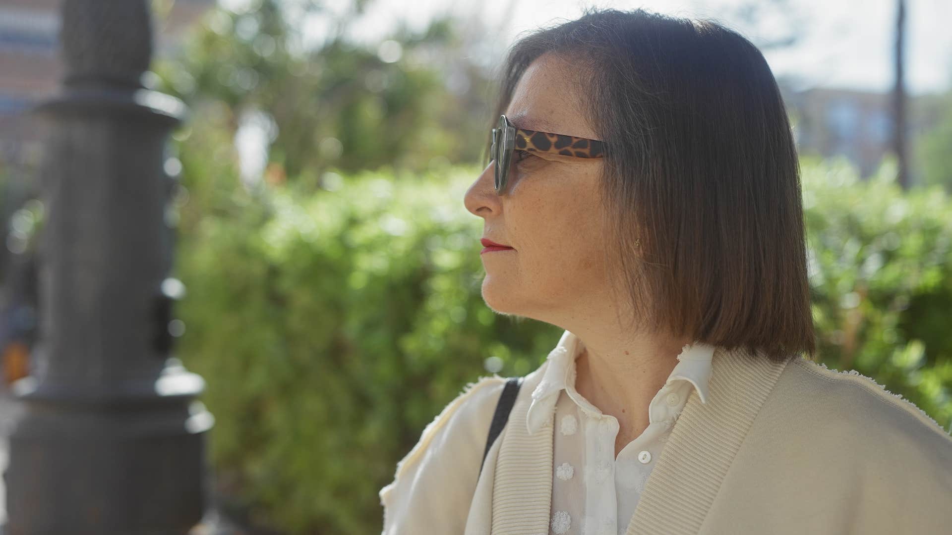 Open-minded woman with shorter hair walking around outside