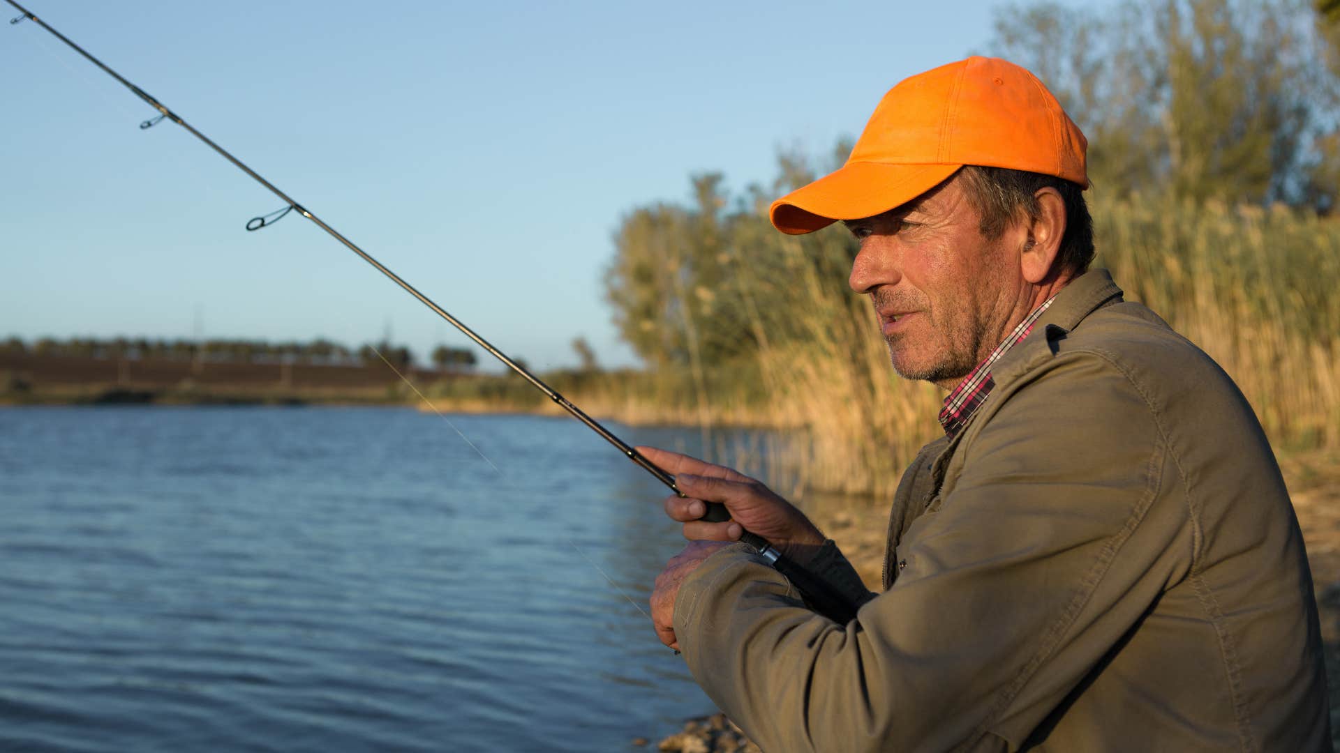 man fishing by water