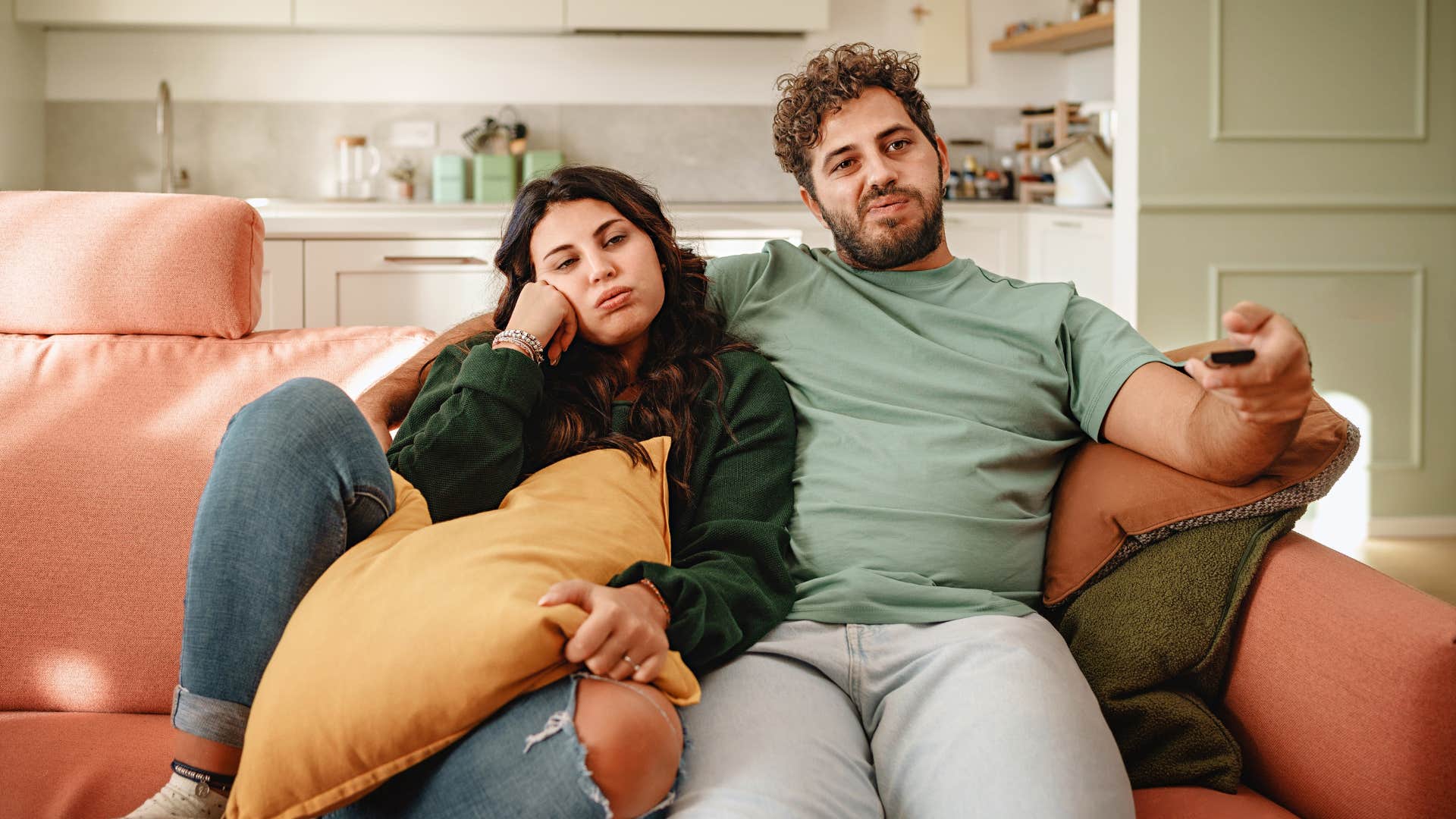 Low-effort couple watch TV showing unlikable trait