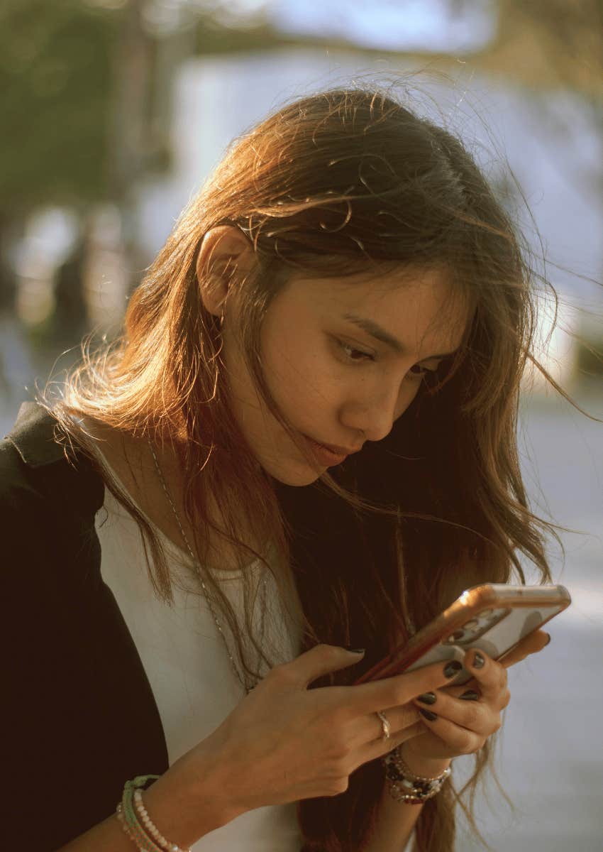 young woman focused on phone