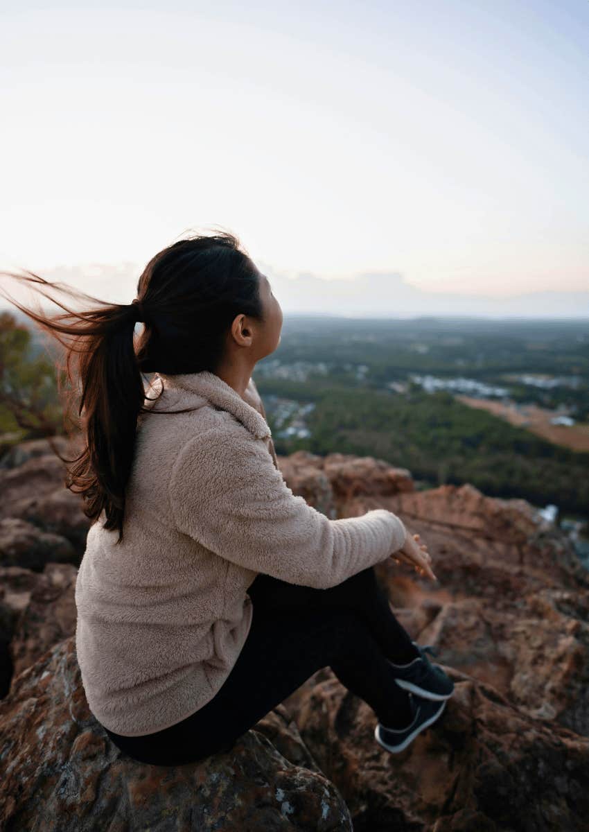 young woman hiking and enjoying the sun