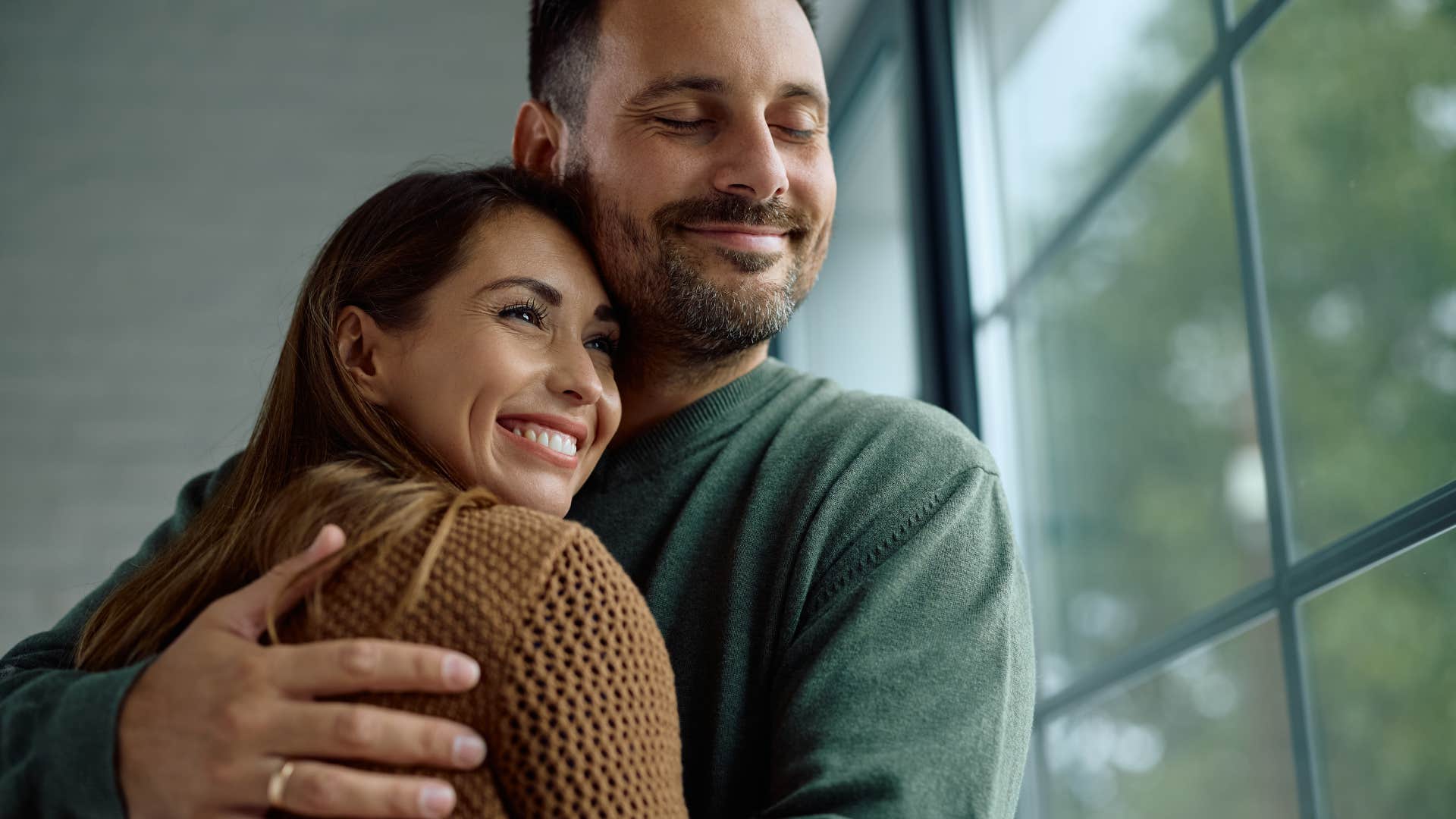husband who loves his wife unconditionally hugging her while saying i'm really lucky to have you
