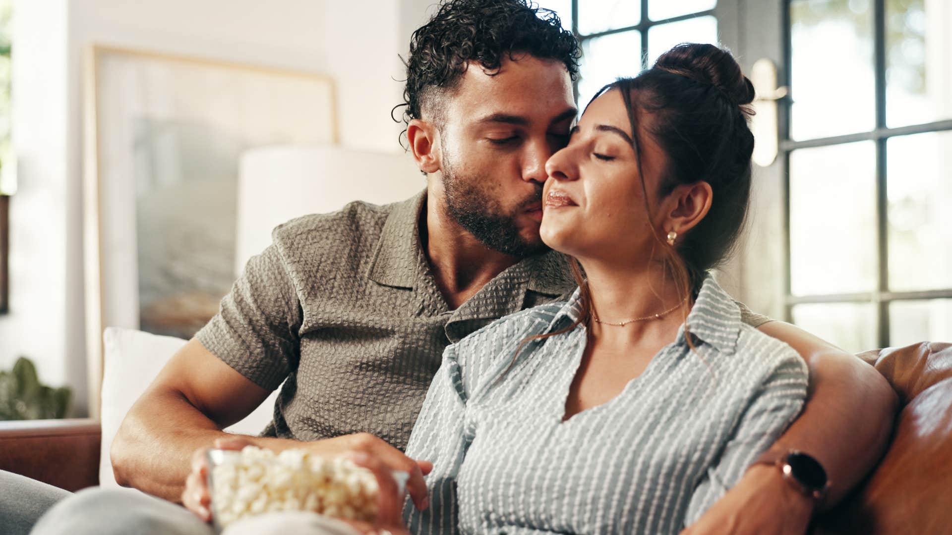 husband kissing wife's cheek telling her you make difficult moments easier to face