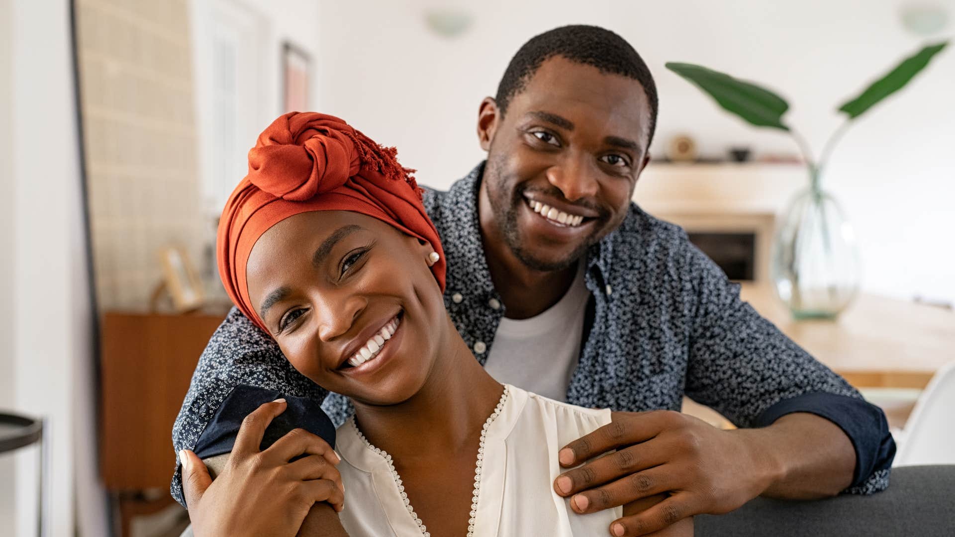 smiling couple sitting together with husband telling wife you make our future feel exciting