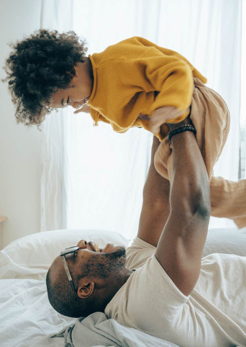 adult man playing with child