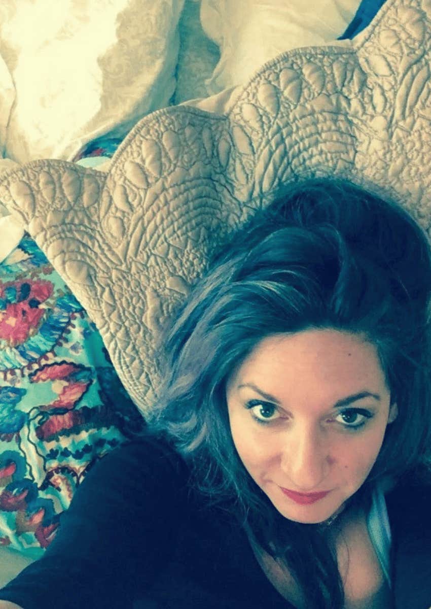 author laying in her bed alone