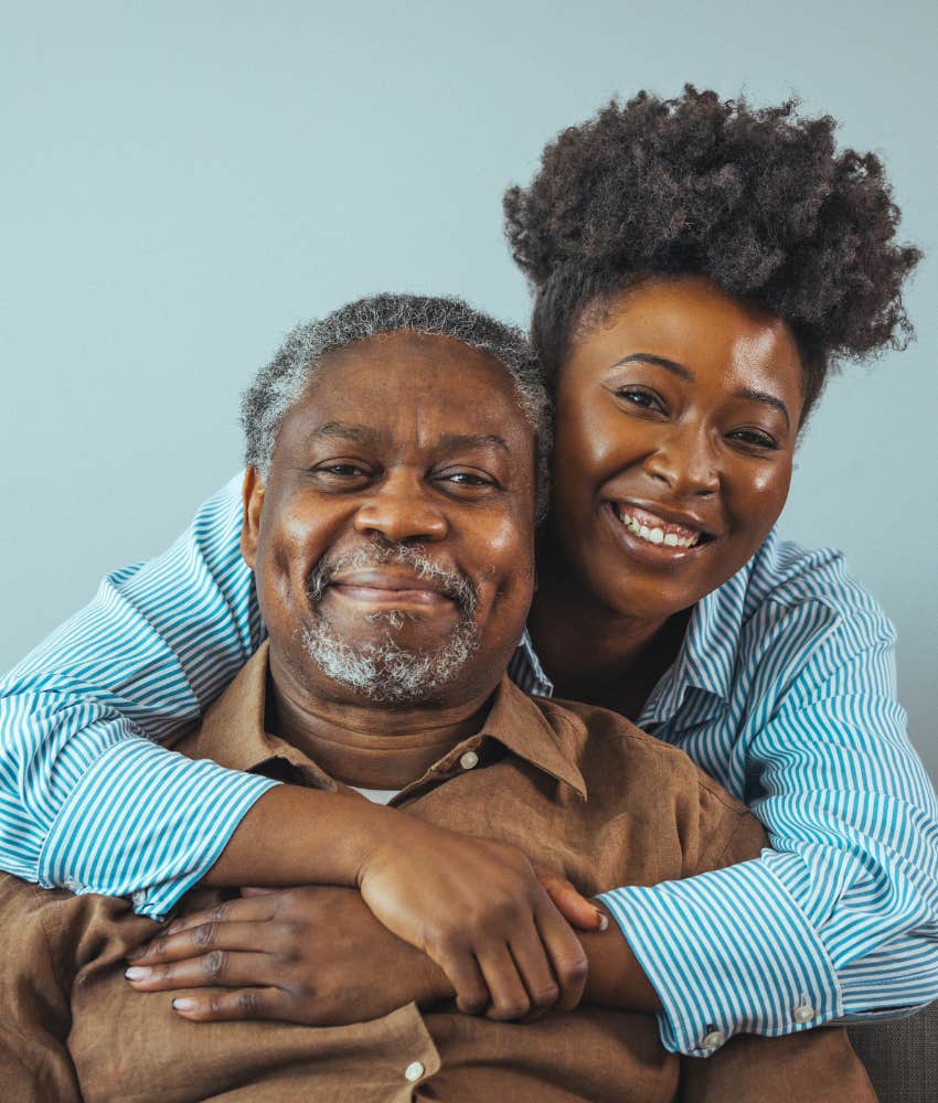 Boomer parent and adult daughter embrace showing acceptance