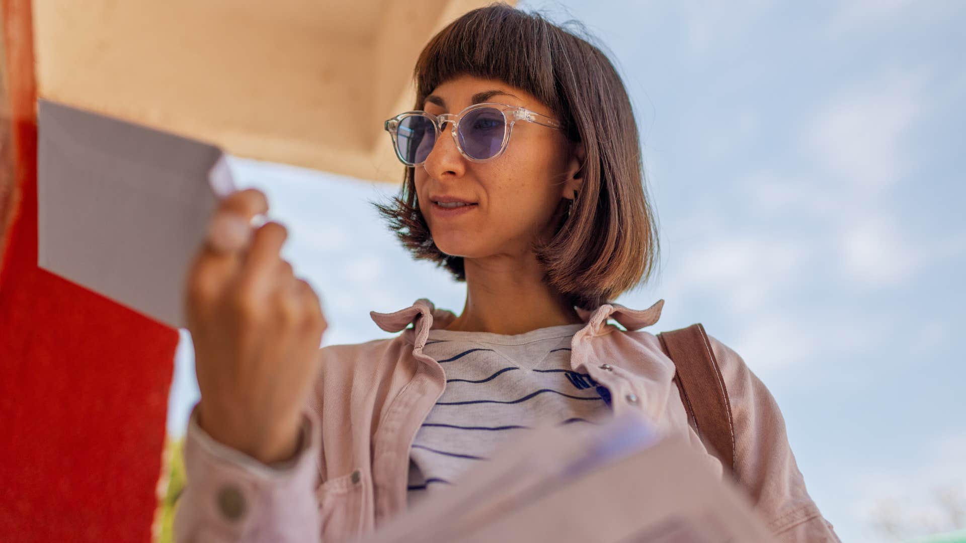 woman looking at receipt seeing angel numbers