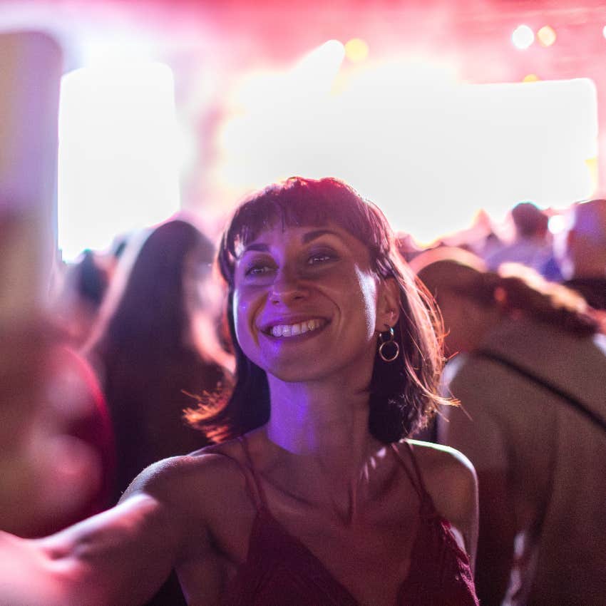 woman taking selfie at concert has a sense of belonging