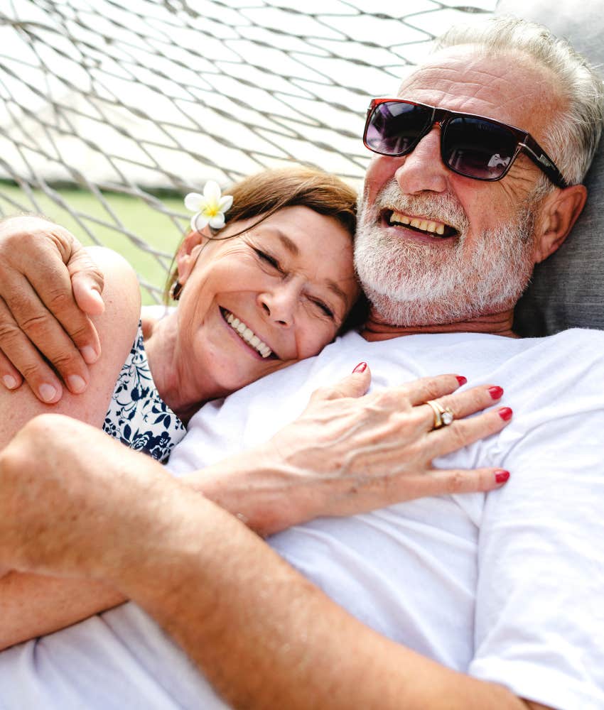 Loving couple cuddle in hammock showing comfortable understanding