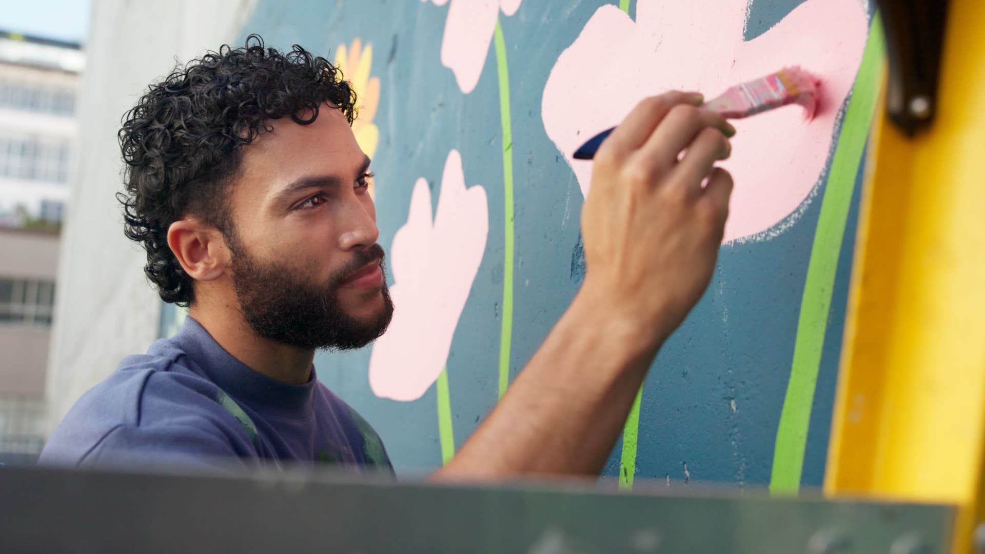 extremely creative man painting on wall