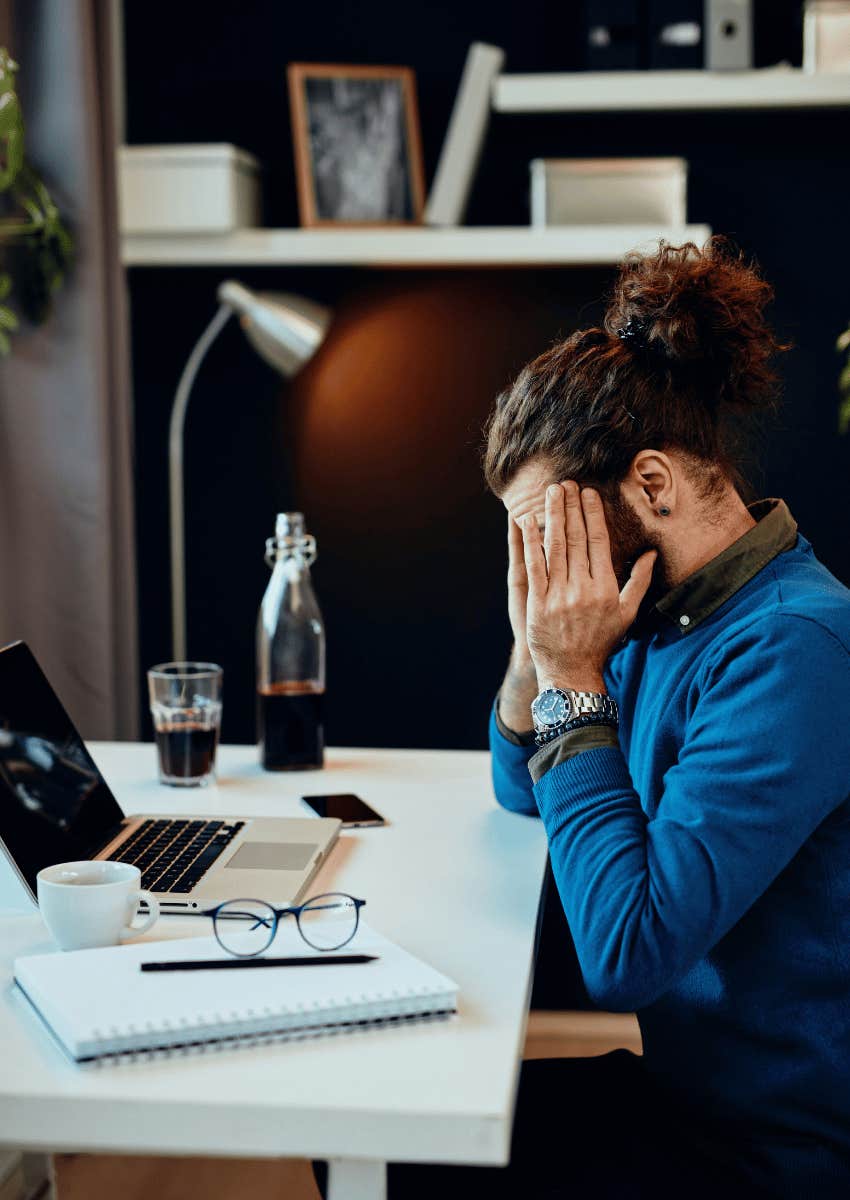 burned out man with his head in his hands