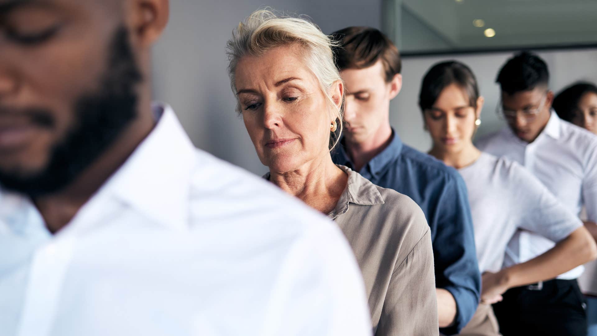 Quiet professionals stand in line showing job they felt trapped in was not failure