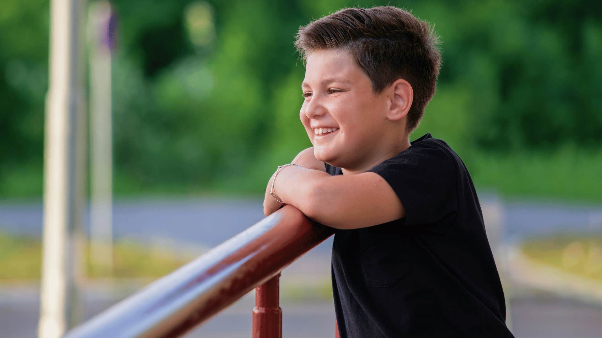 care free son smiling outdoors allowed to be in his joy