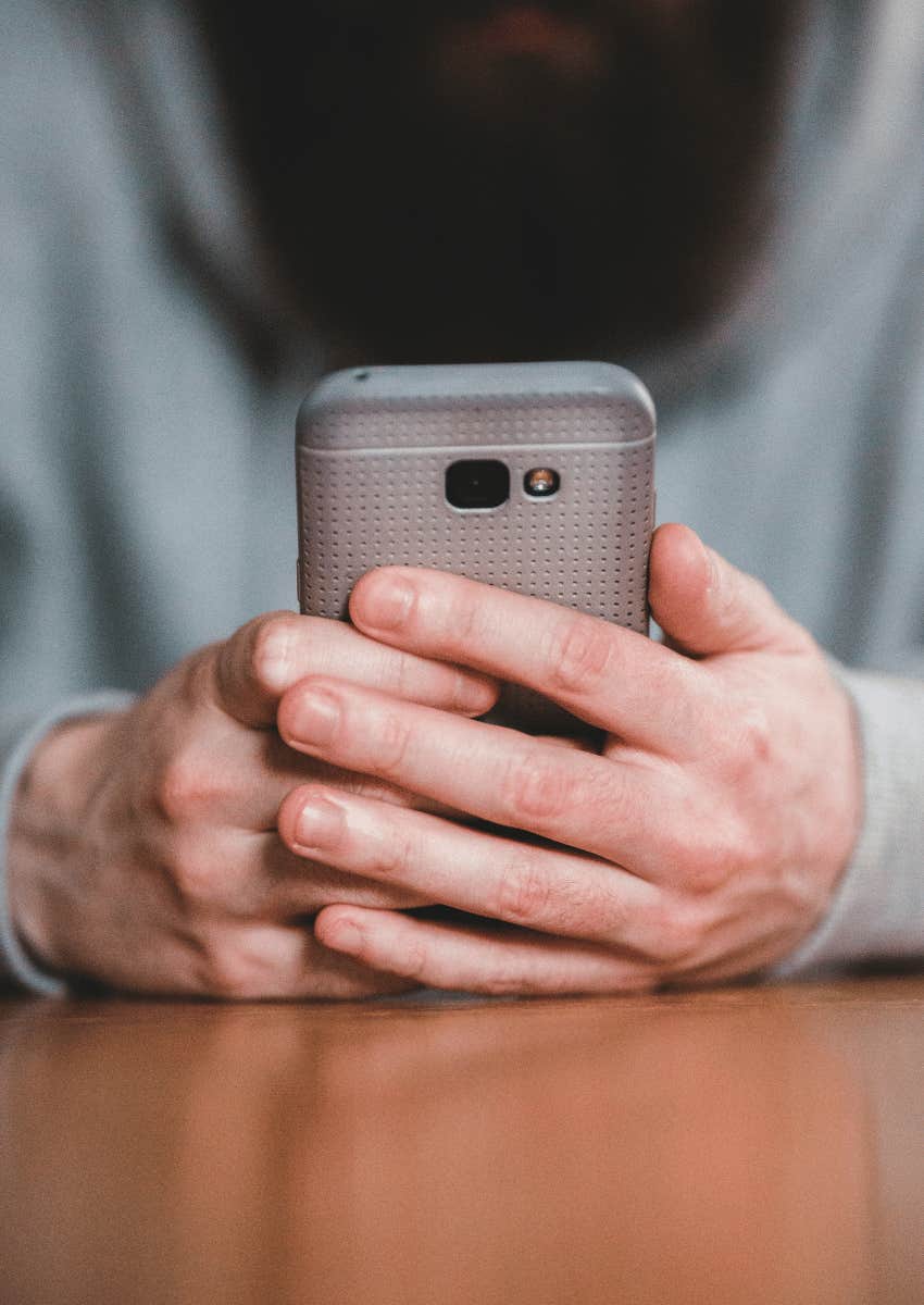 close up of hands holding phone