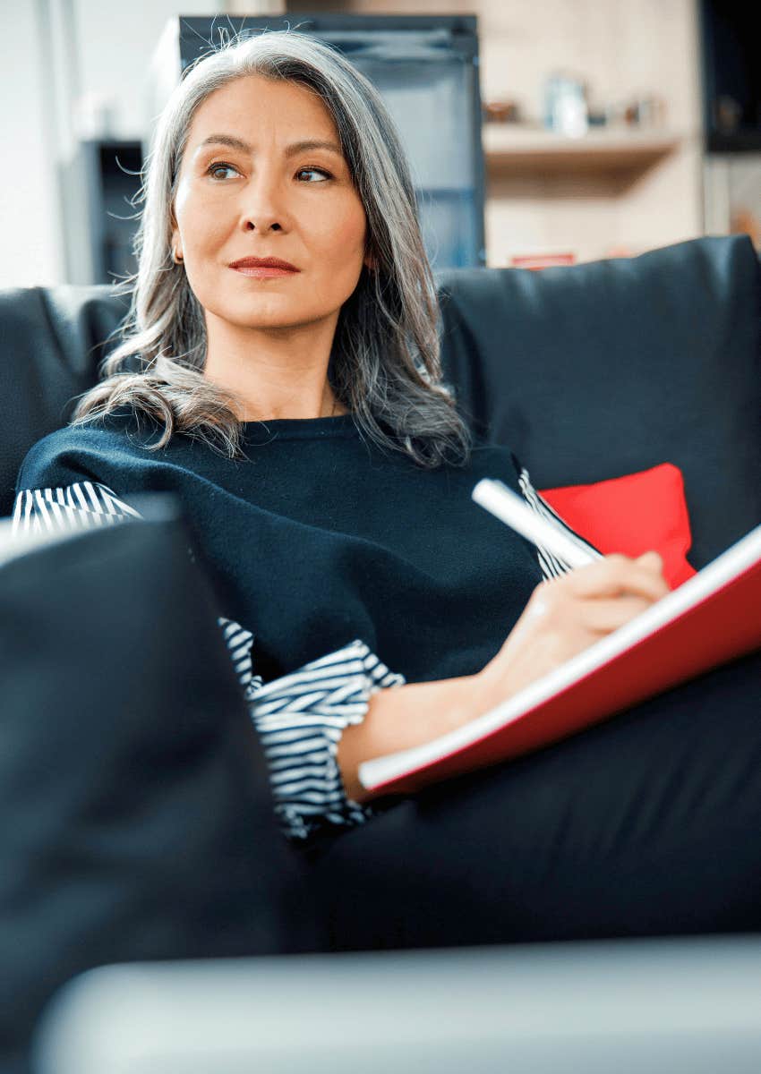 content older woman journaling to feel happier as she ages