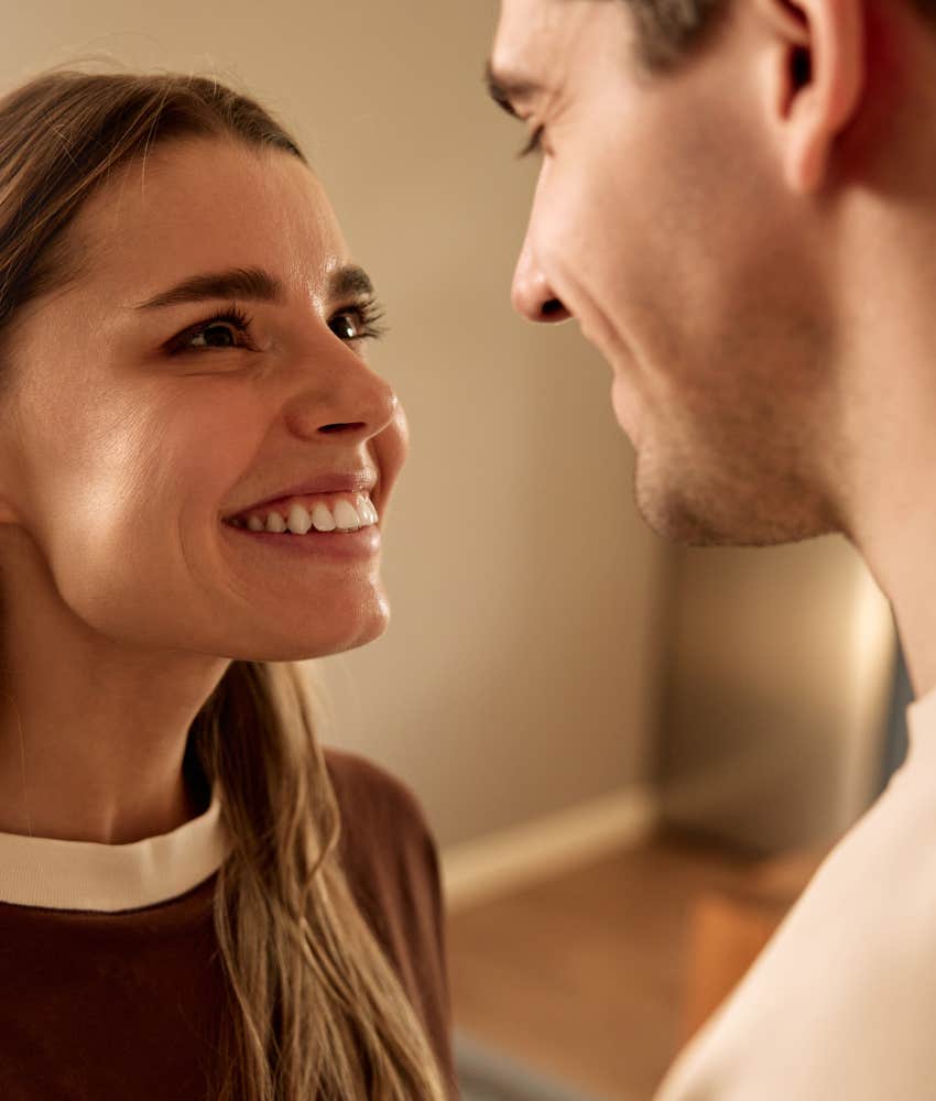 Loving person gazes into partners eyes showing can't stop thinking about ex