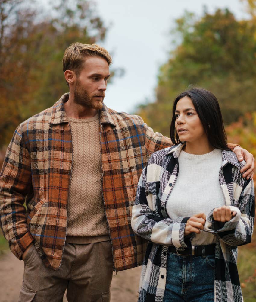 Serious couple walk showing can't stop thinking about ex in life