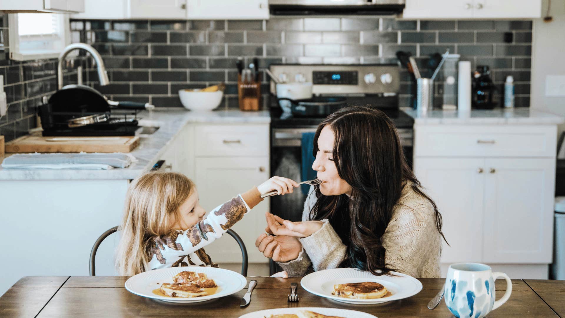 daughter wanting to feed mother and mother letting her