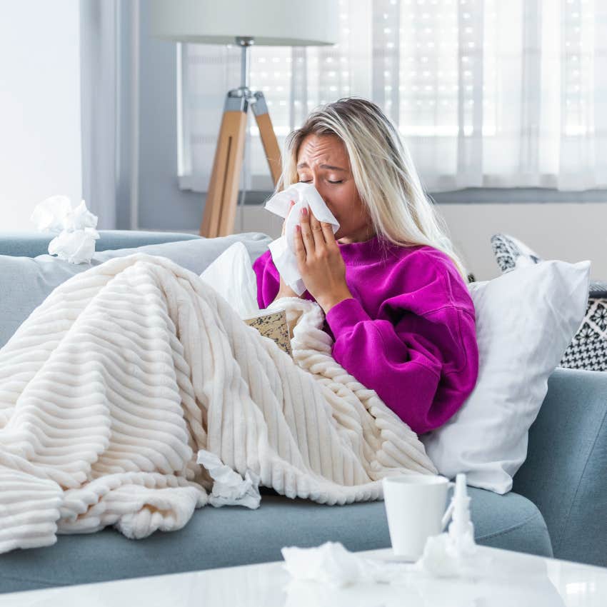 blonde woman home sick on the couch