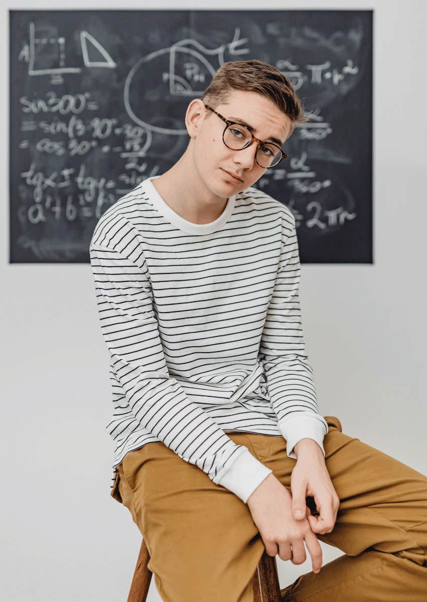 embarrassed teen boy posing reluctantly