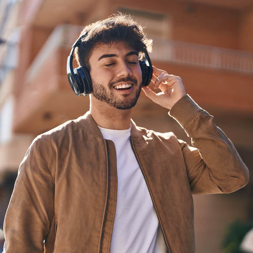 happy man listening to music he loved in high school because it engages his brain