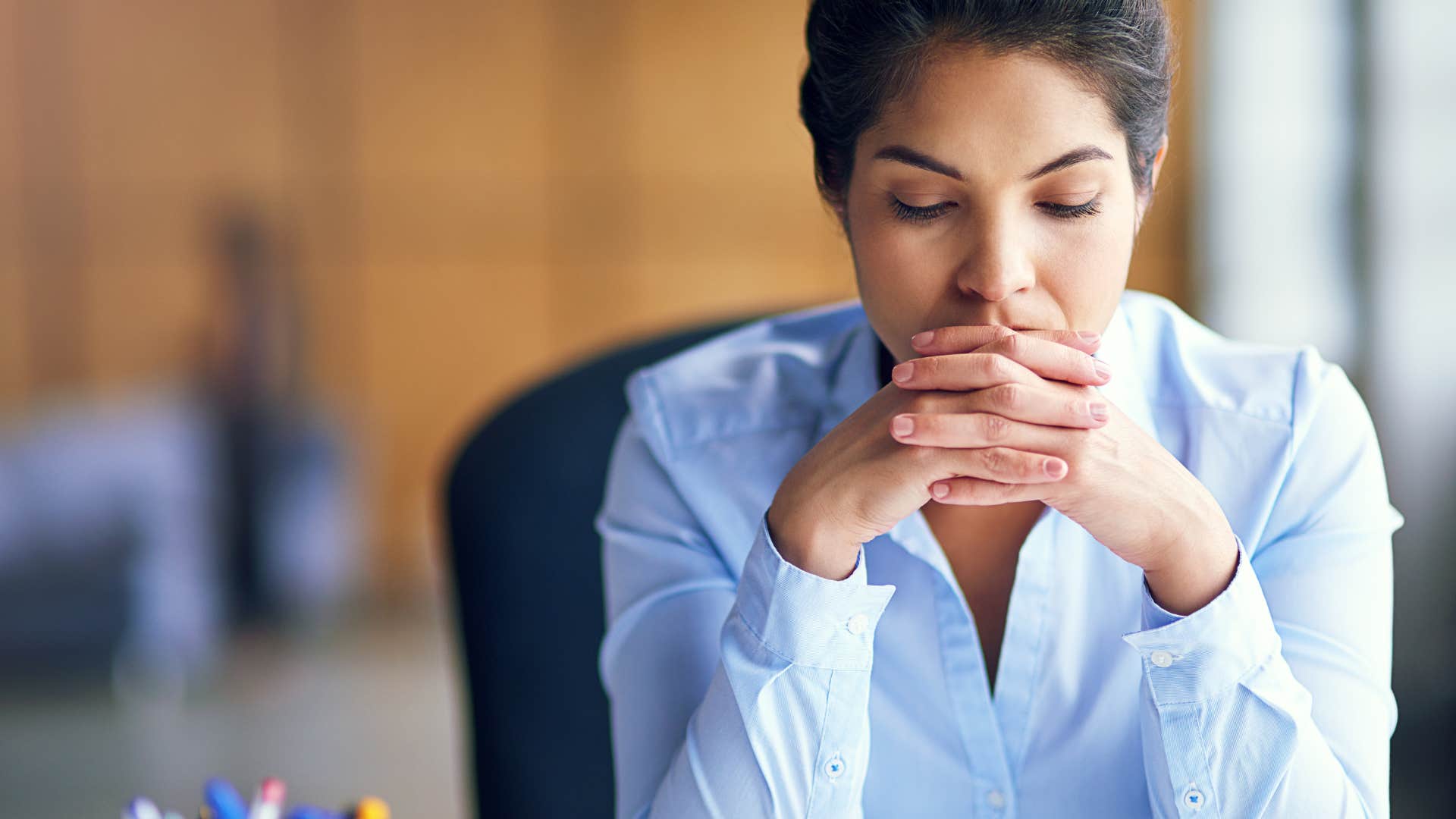 frustrated woman with adhd traits sitting at desk hearing beeping