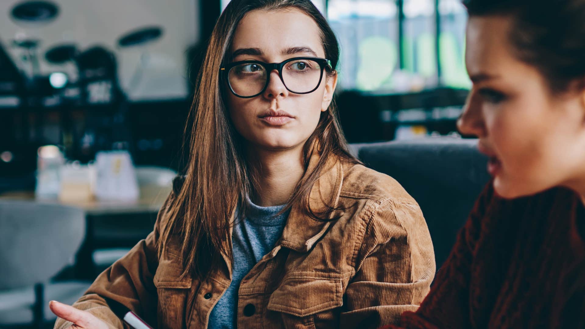 annoyed woman looking at friend who is mouth breathing