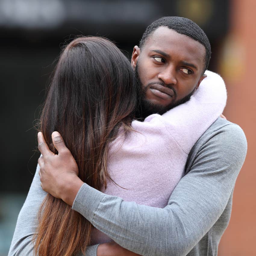 man with an authenticity mayor feeling suspicious of fake woman hugging her