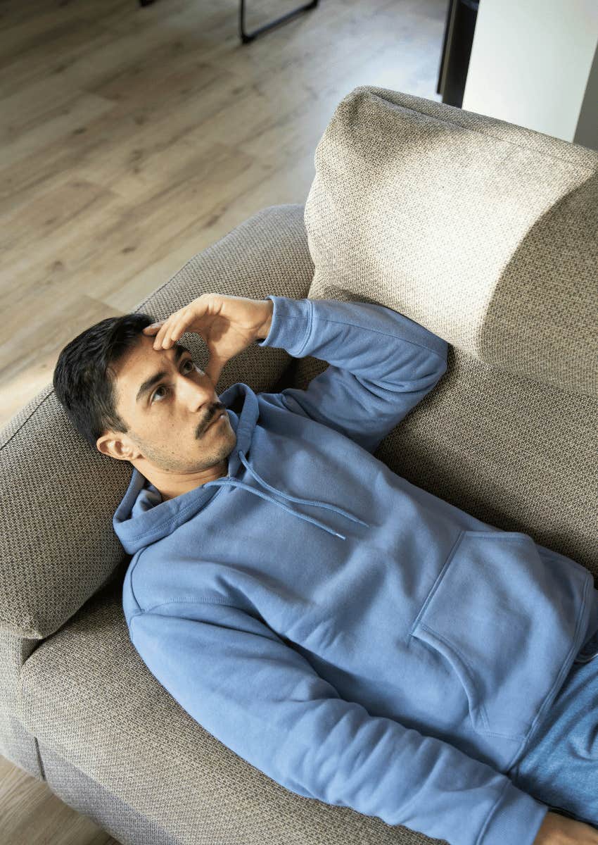 forgetful young man laying on the couch