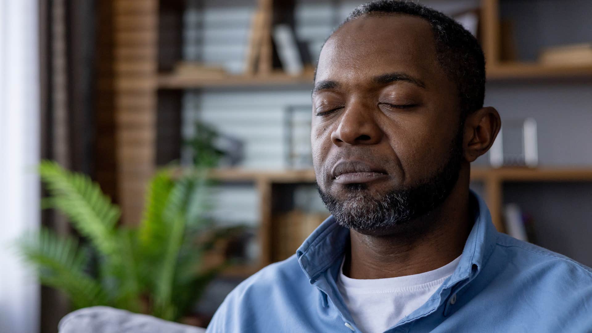 Man who appreciates slowing down sitting alone at home.