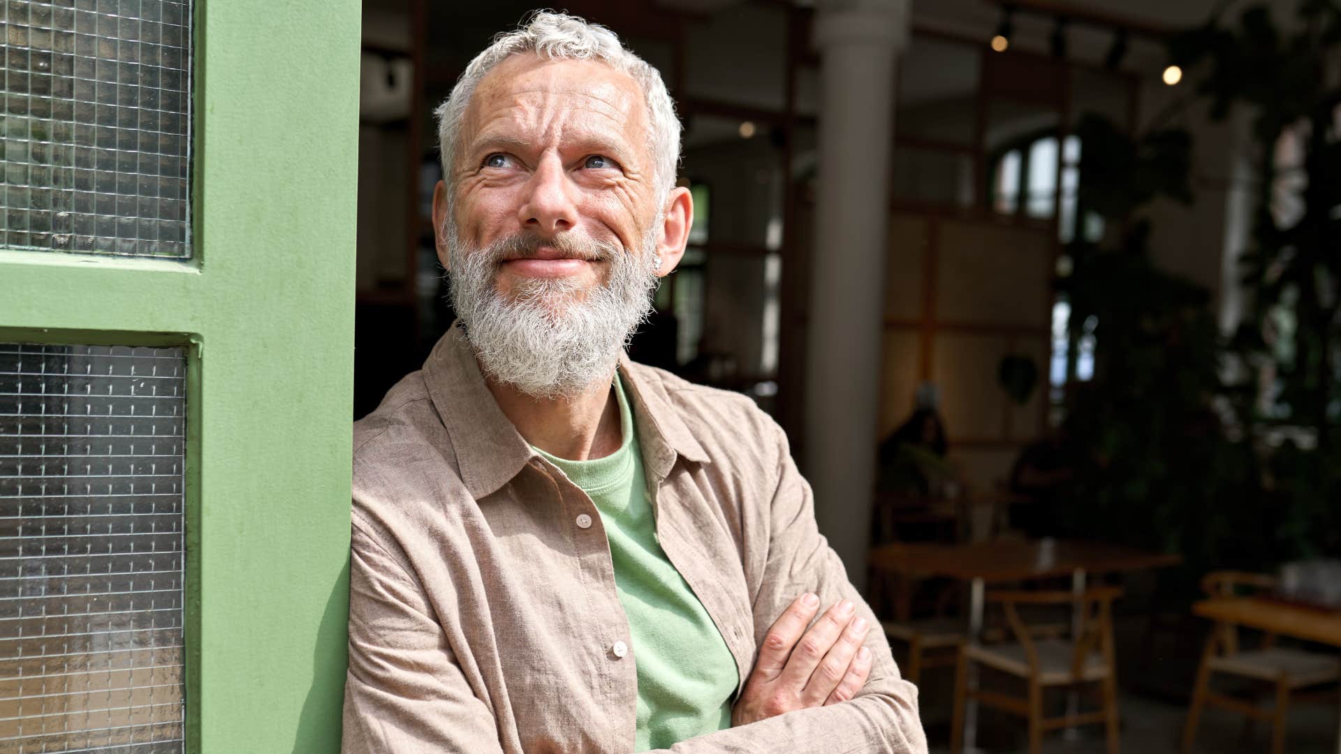 Satisfied Gen-Xer look up and grins showing midlife point of view