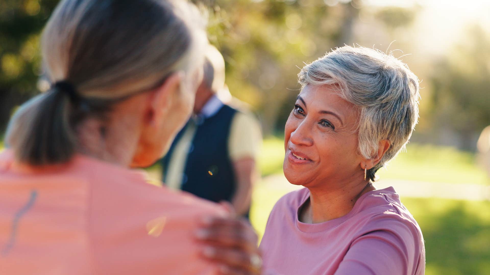 Woman who only makes space for healthy, authentic friendships smiling outside.