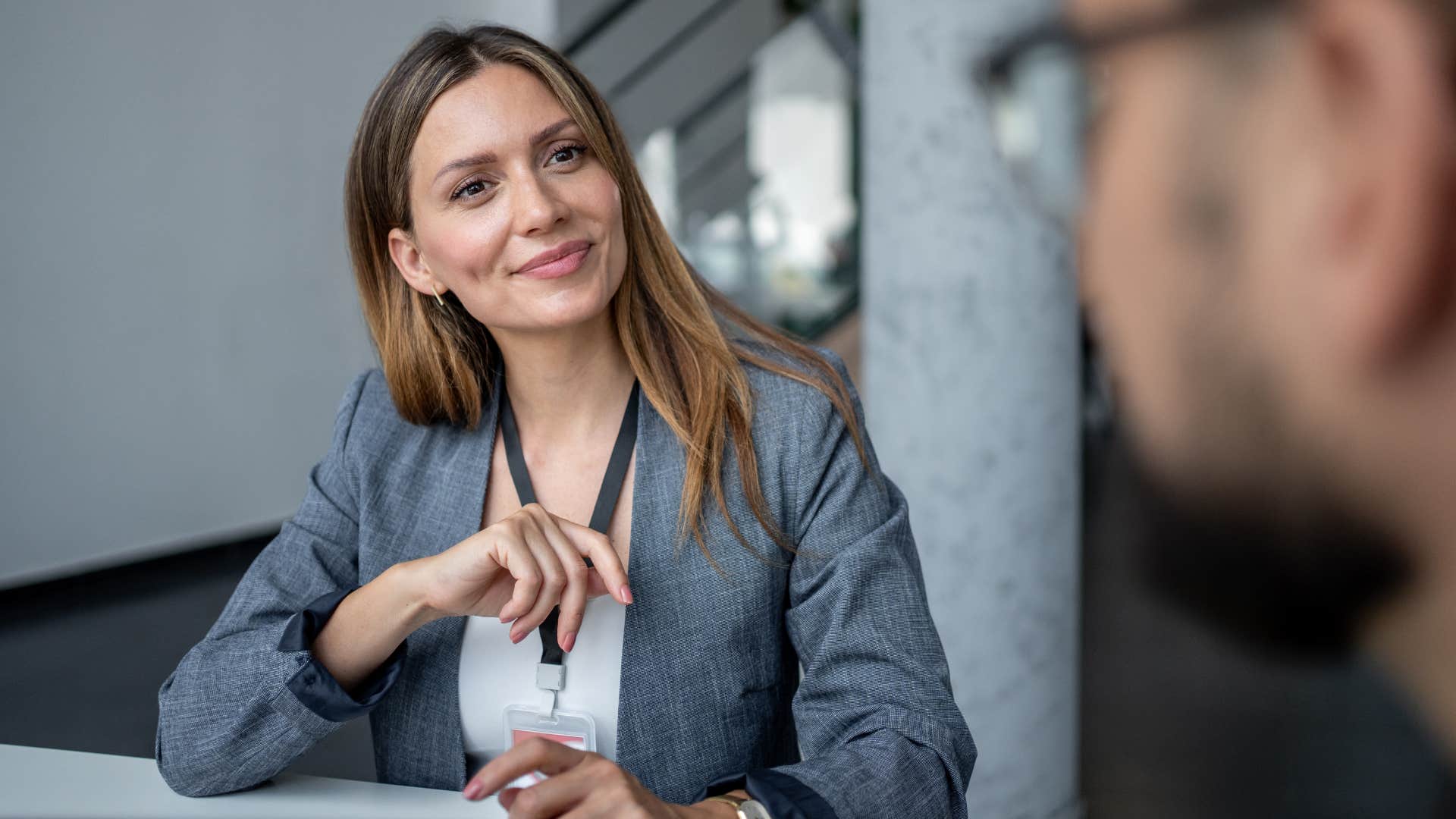 Socially aware woman listening to a man at work.
