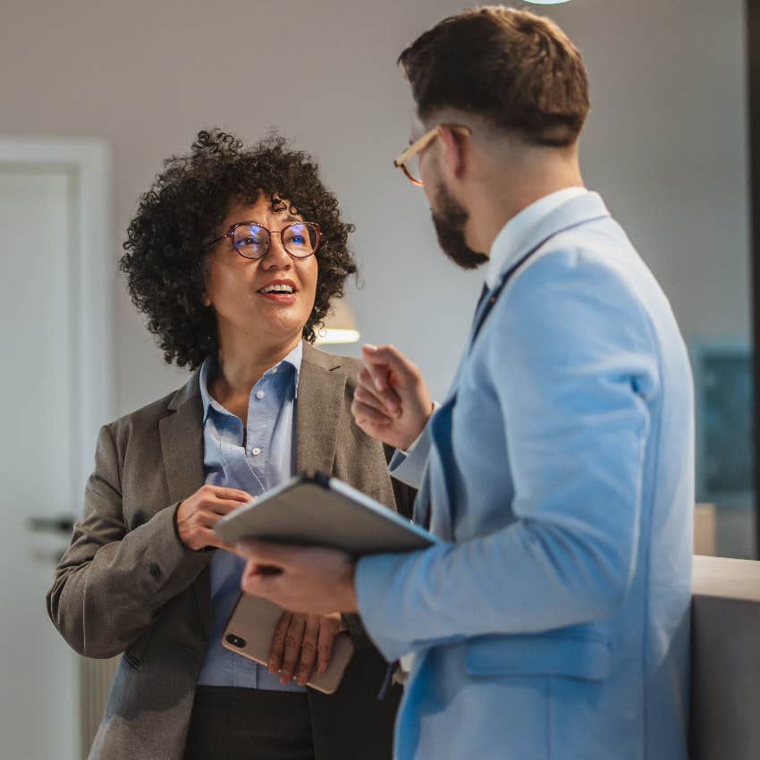 female worker asking coworker for help