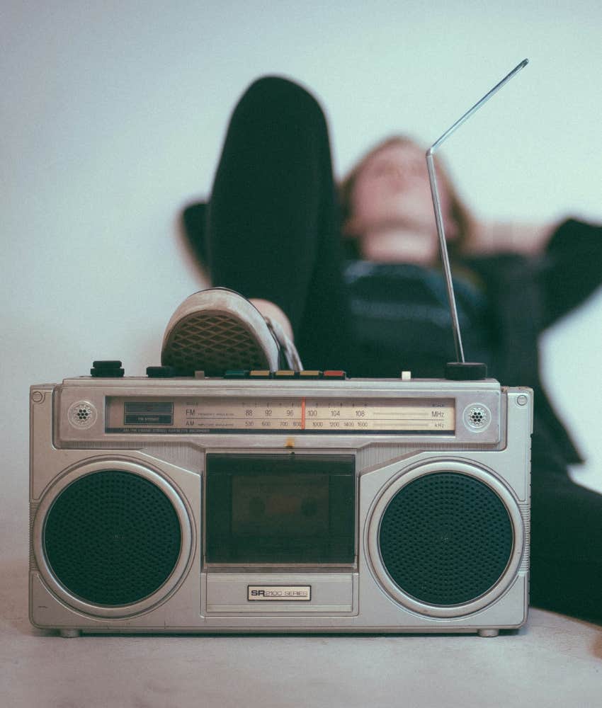 Retro image of teenager resting foot on 1980s boombox showing revisit memories