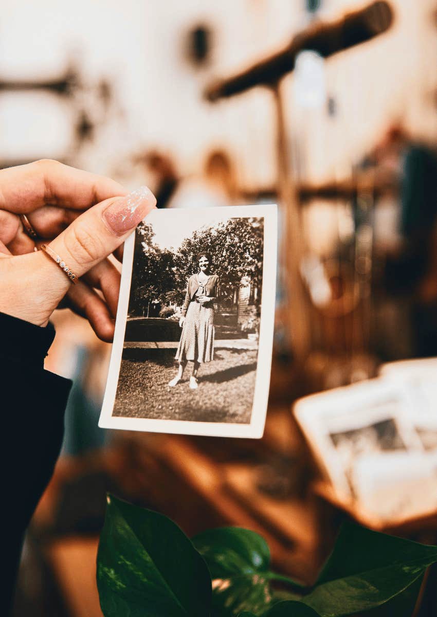 hand holding a photograph not wanting to trade the memories
