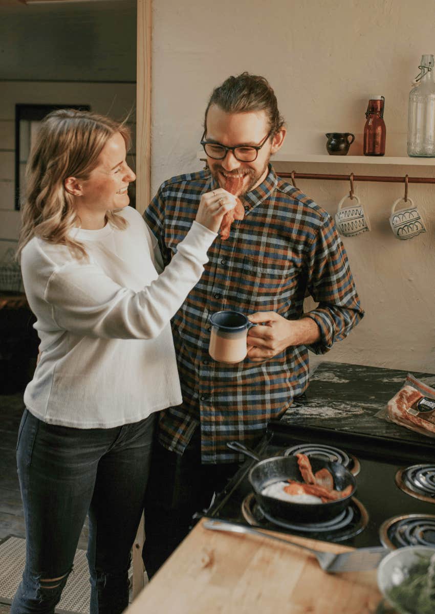 happy couple cooking breakfast together