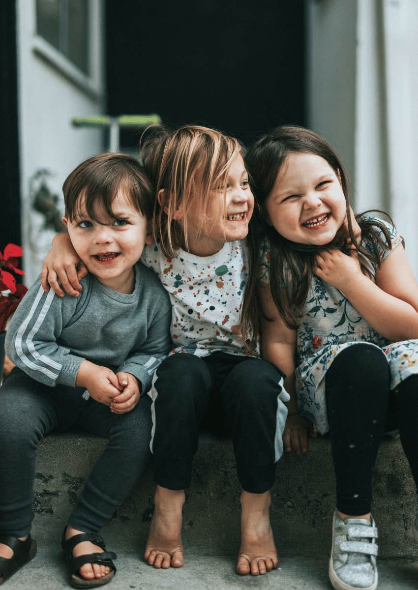 happy neighborhood kids on a playdate sitting together