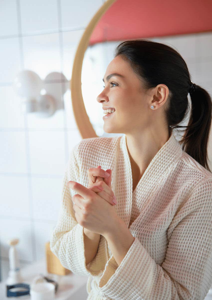 happy woman wearing a robe after shower