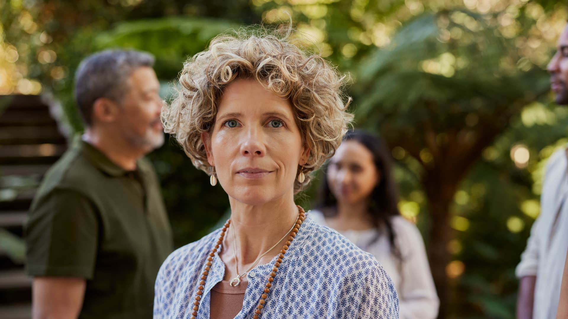 Middle age woman with other people showing realization about getting older