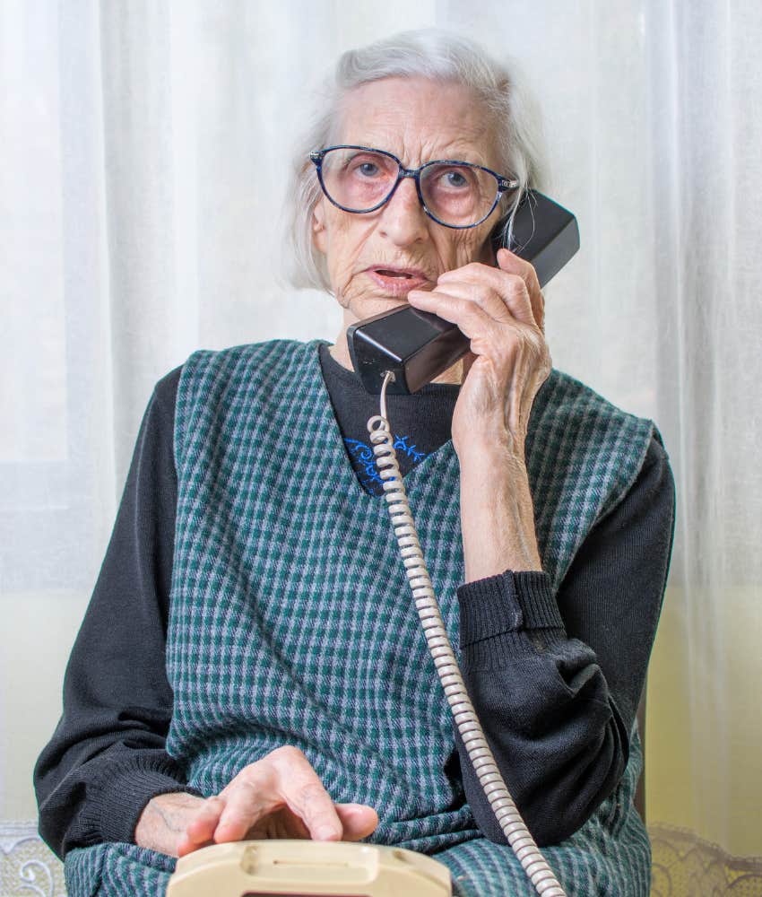 Stern elderly woman answers phone
