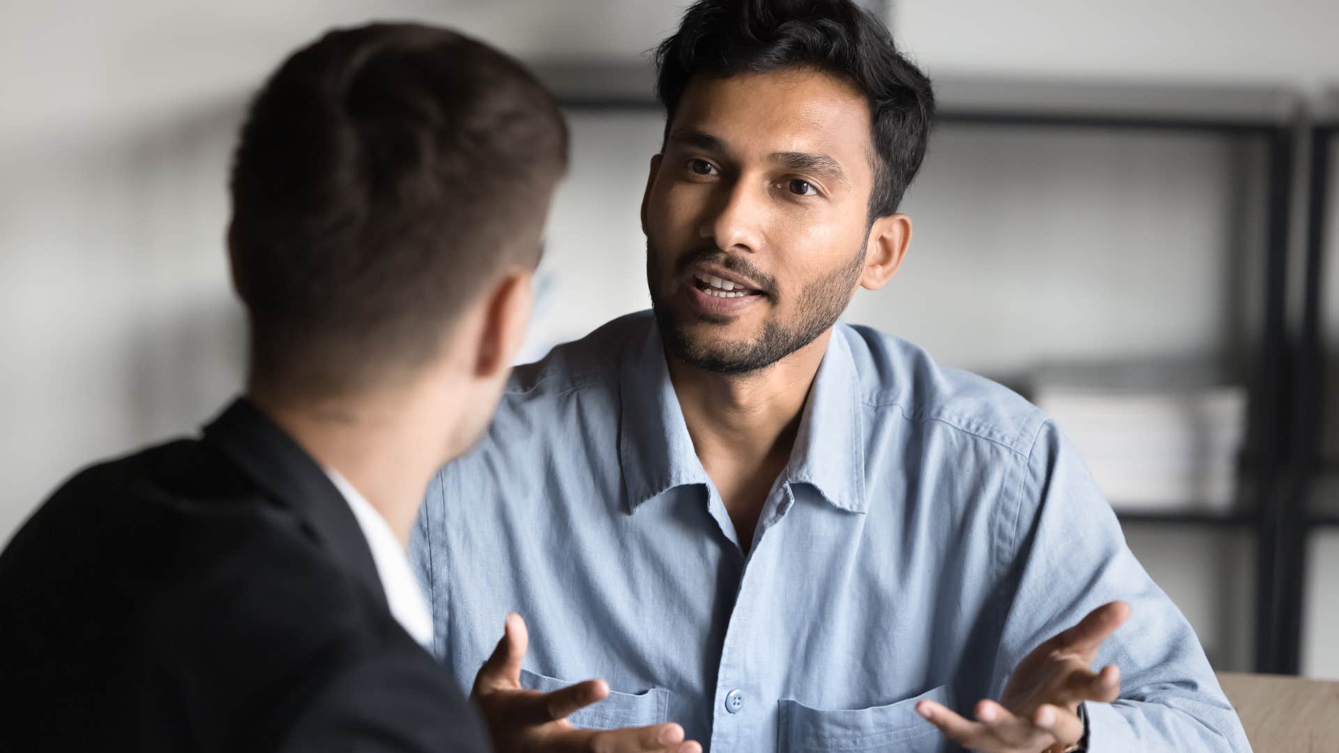 high-iq man saying let's take a step back to his co-worker