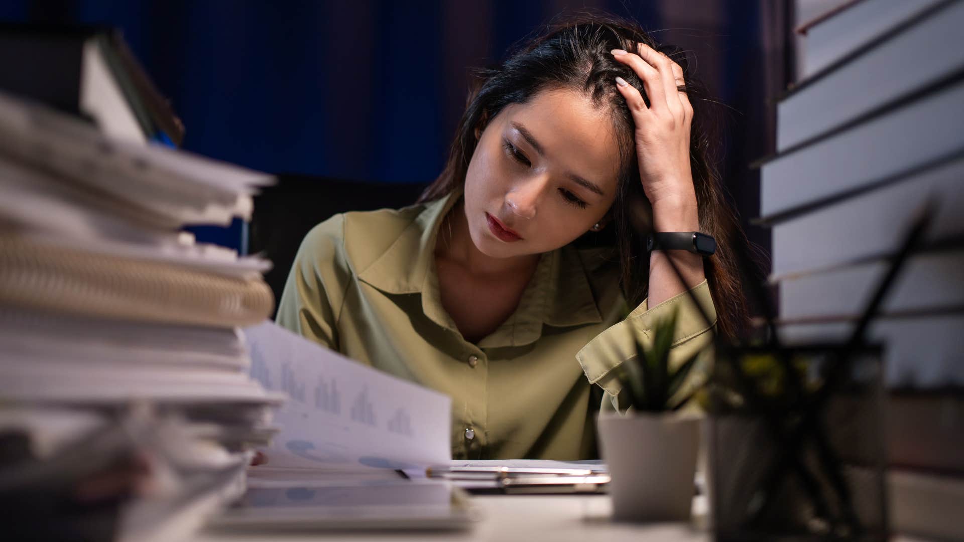 woman who has high expectations and lofty goals to reach working late