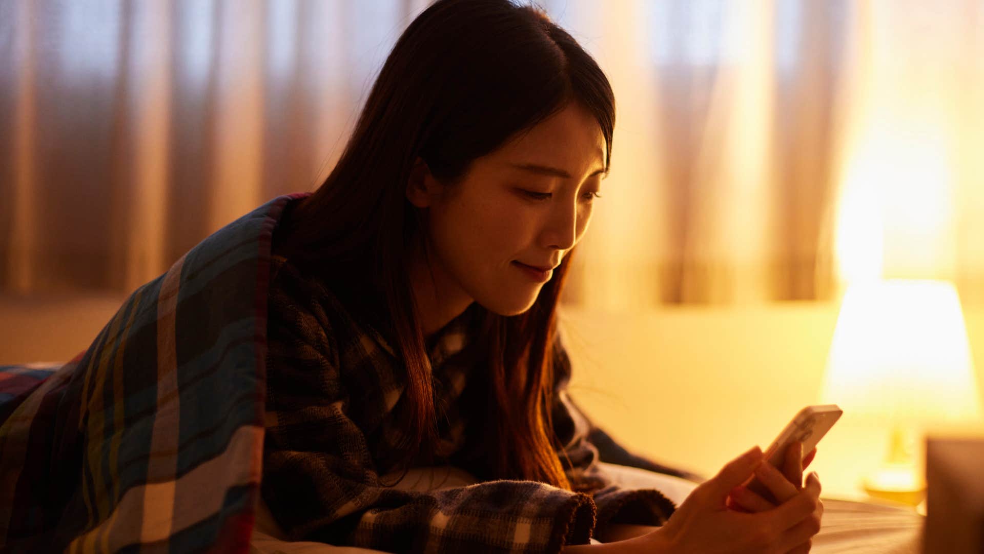 woman who needs time to wind down at night on her phone