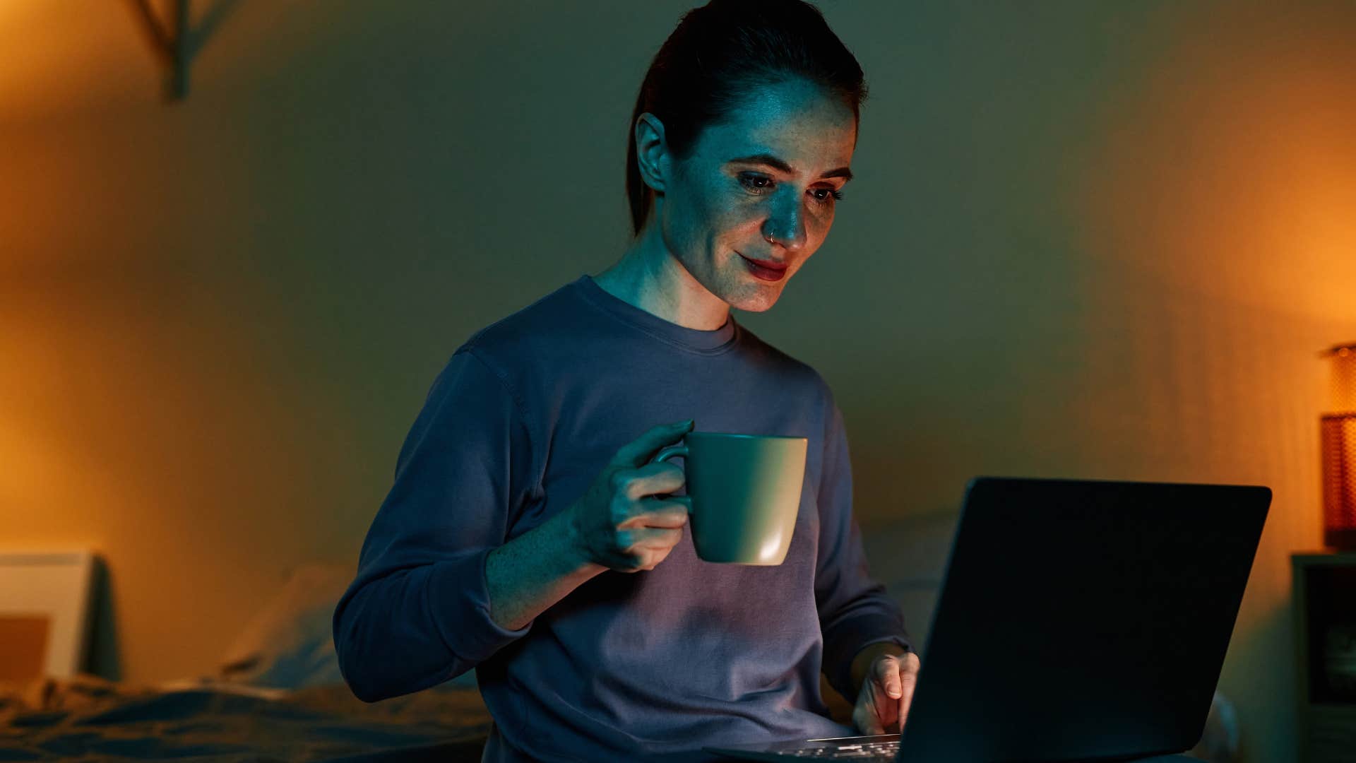 tired woman up late at night questioning natural norms on her computer